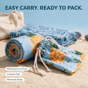 microfiber beach towel spread on a sandy shore.